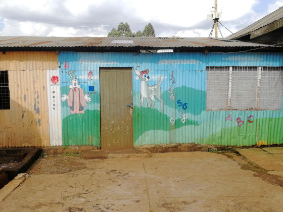 A corrugated iron structure painted with a bright picture likely to appeal to young children